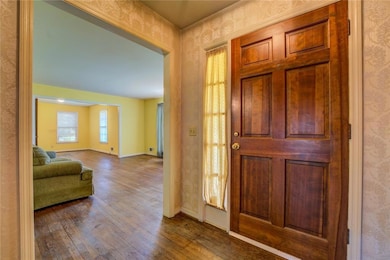 Entrance foyer featuring baseboards, wallpapered w