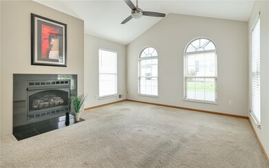Updated gas log fireplace with decorative marble tile.