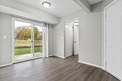 Unfurnished bedroom with dark wood-style flooring and access to exterior