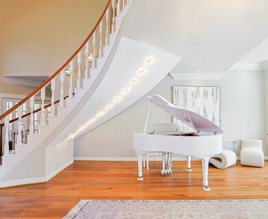 A breathtaking curved staircase with wooden handra