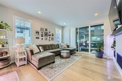 Engineered hardwood floors gracefully lead you through the main living areas. Sliders off the light-filled living room lead to the covered deck.