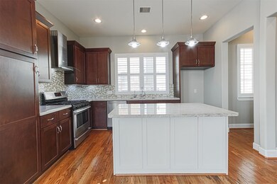 Island kitchen with breakfast bar and pendant ligh