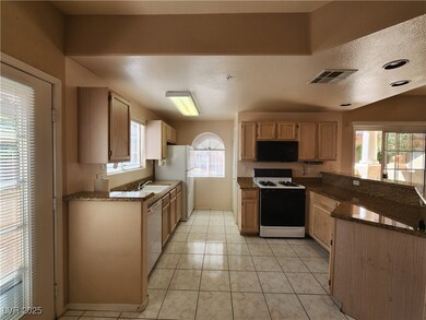 Kitchen featuring white appliances, a peninsula, h
