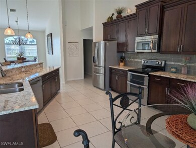 Kitchen featuring stainless steel appliances, a si