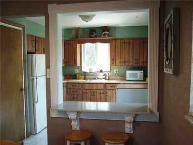 Looking into kitchen from dining room showing brea