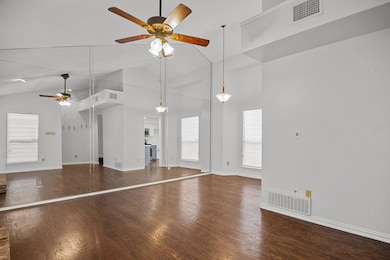 Unfurnished living room with ceiling fan, hardwood