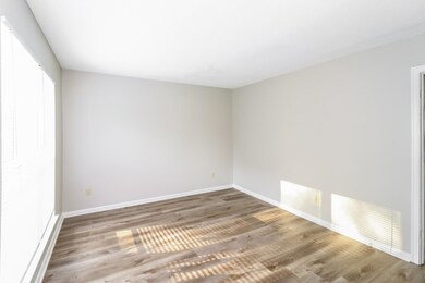 Spare room featuring wood finished floors and baseboards