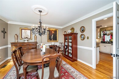 Dining space featuring ornamental molding, light w