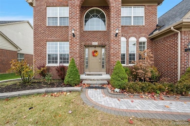 Property entrance featuring brick siding and a yard