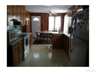 Kitchen. All appliances included. Door exits to ba