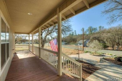 Covered front porch overlooking front courtyard