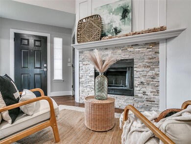Living room with baseboards, wood finished floors,