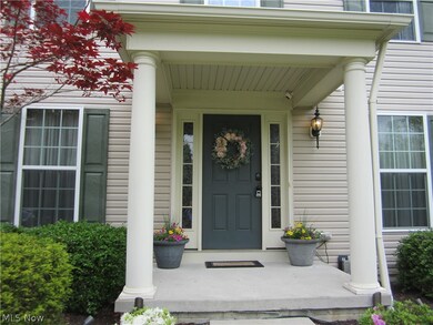 View of exterior entry featuring covered porch