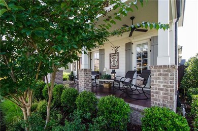 The generous front porch, a perfect hang out, has ceiling fans and a stained concrete floor.
