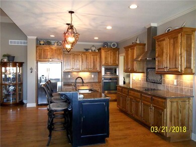 Kitchen showing Wood Floors, Custom Cabinets and I