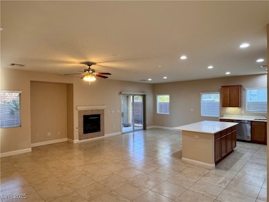 Kitchen with stainless steel dishwasher, light cou