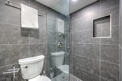 Full bath with toilet and tiled shower