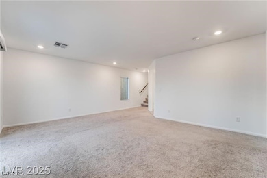 Spare room featuring light carpet, stairway, and r