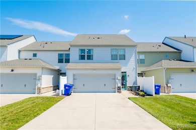 View of front of home featuring stone siding, a ga