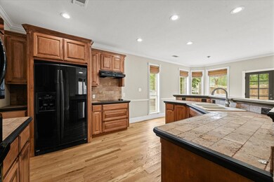 Kitchen with tasteful backsplash, ornamental moldi