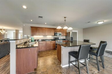 Spacious eat-in kitchen overlooks the backyard and