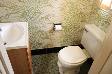Bathroom featuring toilet, tile patterned floors, 