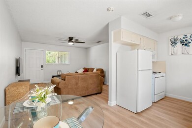 Dining space featuring ceiling fan and light wood