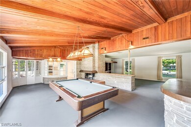 Rec room with wooden ceiling, brick wall, vaulted