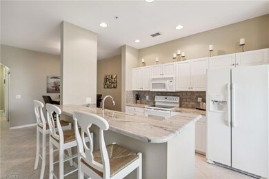 Kitchen featuring white appliances, light tile pat