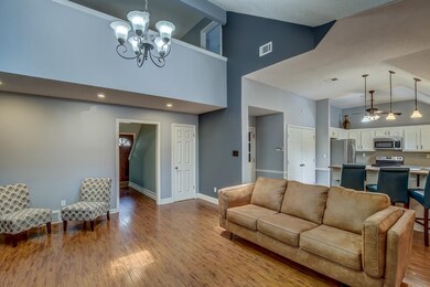 Living room with high vaulted ceiling, ceiling fan