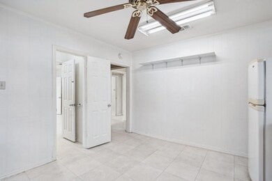 Unfurnished room with crown molding and ceiling fa