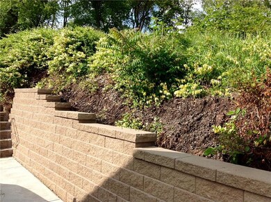 Retaining wall next to driveway/patio in back of h