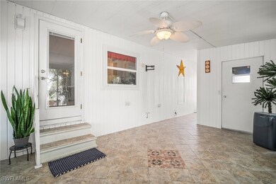 Property entrance with a ceiling fan and a patio