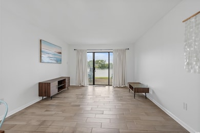 Unfurnished living room with wood finished floors and a water view