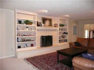 Great room has painted brick fireplace & hearth fl