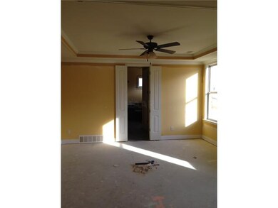 Large master bedroom with trey ceiling.