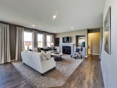 The family room has large windows that bring in th