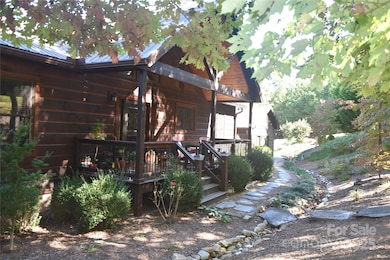 Summer view of the front of home and shade trees.