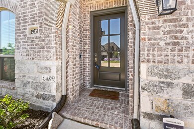 A covered entryway leads to the front door, which