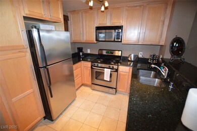 Kitchen with light tile patterned floors, stainles