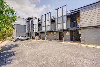 View of building exterior with uncovered parking