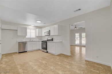 Kitchen with stainless steel appliances, a sink, l