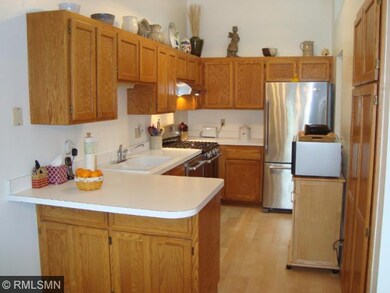 Large kitchen with stainless steel appliances. Oak
