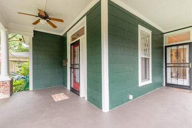 Covered porch featuring a ceiling fan