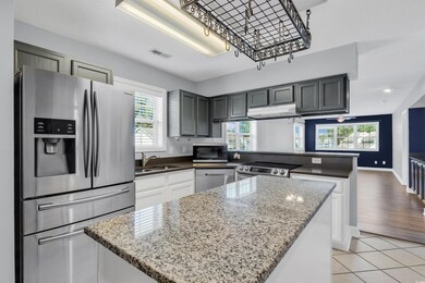 Kitchen featuring light wood-type flooring, applia