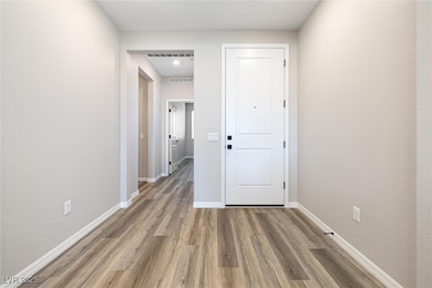 Corridor with wood finished floors and baseboards