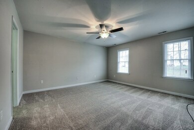 The bright Owner's Bedroom has new carpet, a large