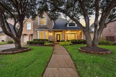 Stunning curb appeal and manicured mature oak trees line your path up the inviting walkway.