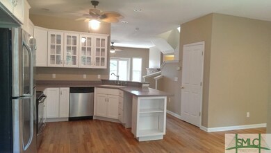 Kitchen is off the open living area on the main le