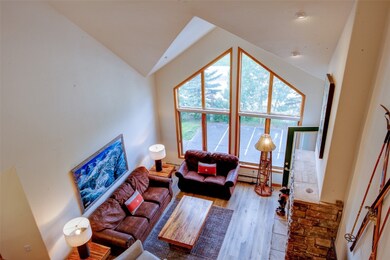Living room featuring lofted ceiling and wood fini